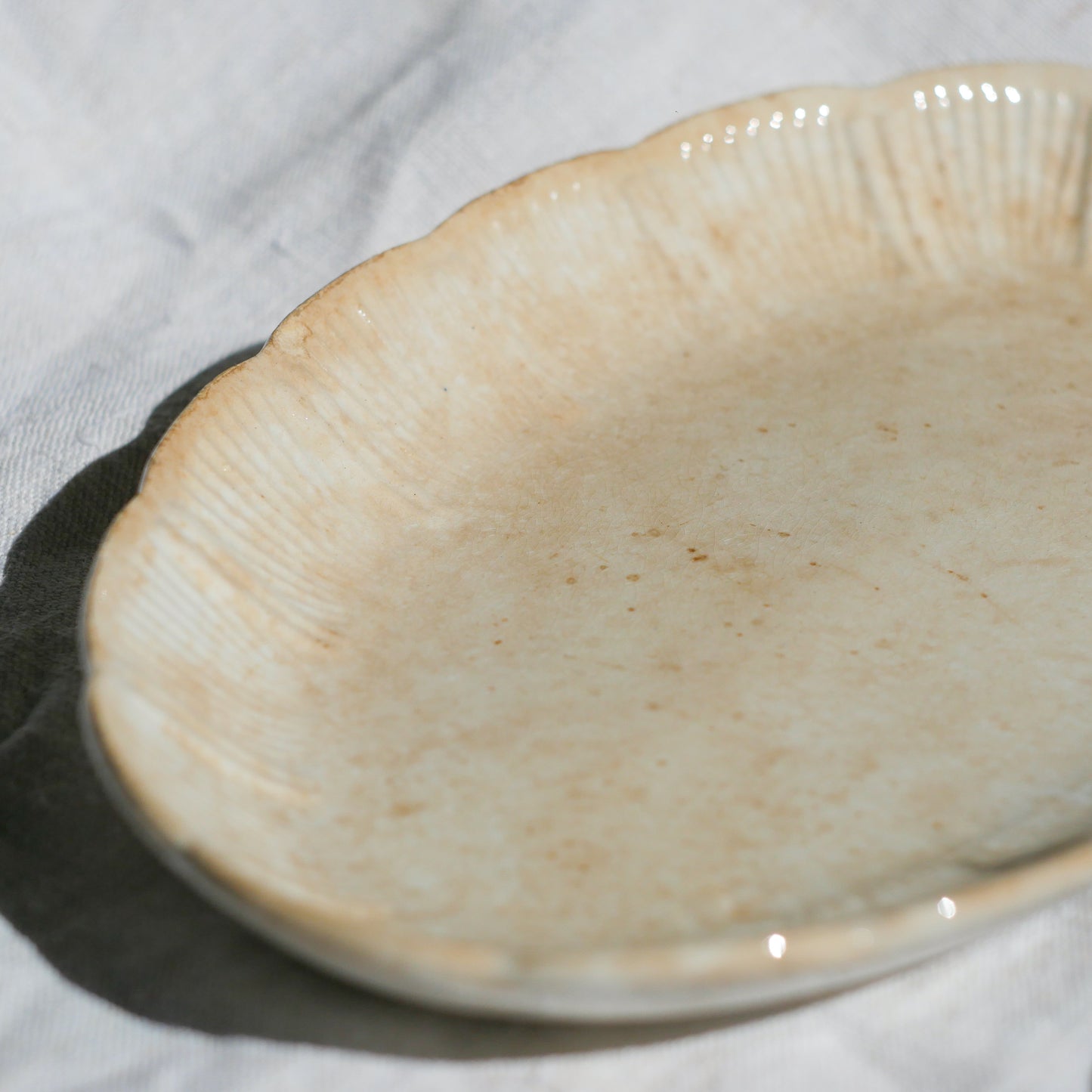 A beautiful pair of French antique ironstone raviers or side plates which over the last century or more have developed a wonderful time-worn and tea-stained finish which make them perfect for shabby chic interior decor. We very rarely come across these little plates lately they're a rare find.