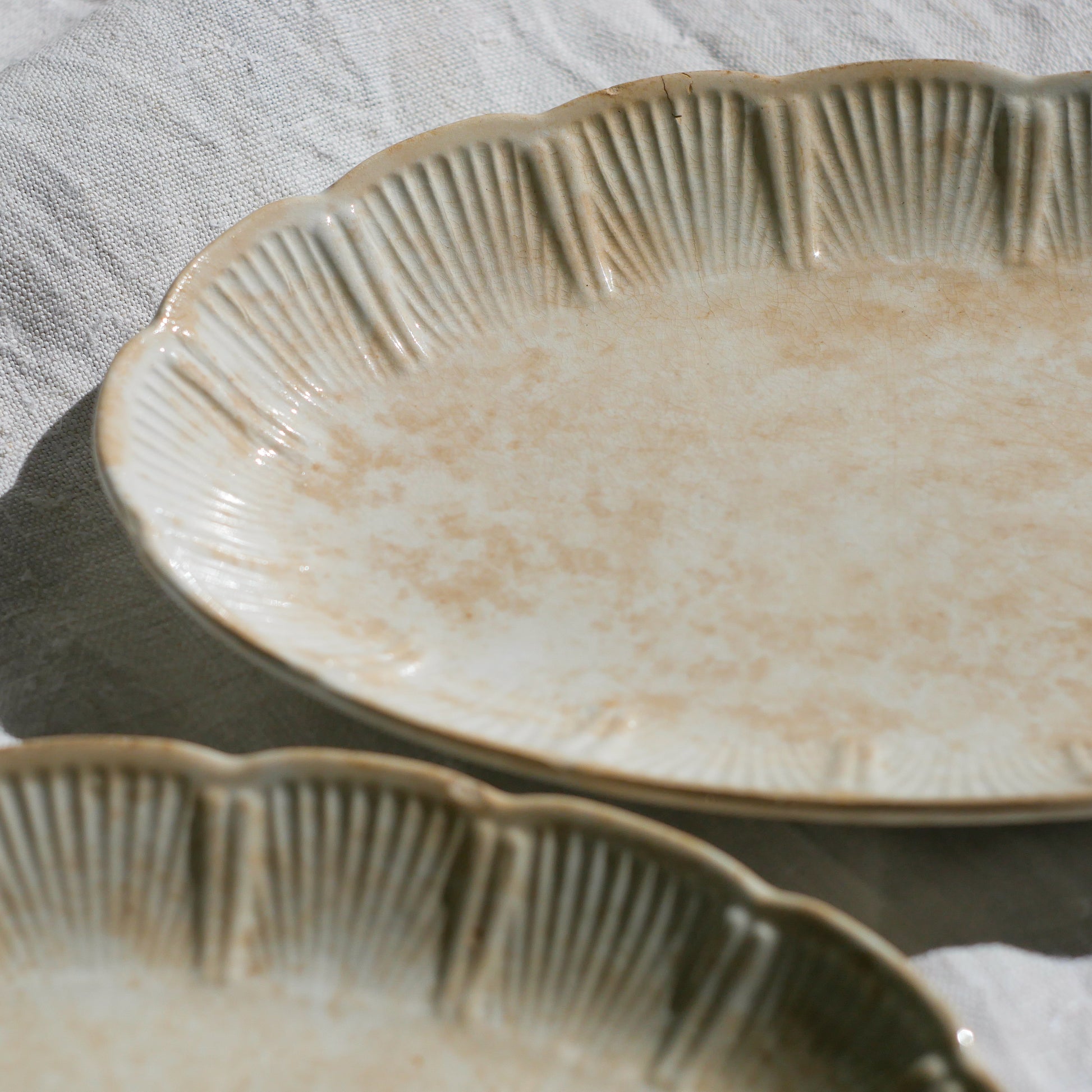 A beautiful pair of French antique ironstone raviers or side plates which over the last century or more have developed a wonderful time-worn and tea-stained finish which make them perfect for shabby chic interior decor. We very rarely come across these little plates lately they're a rare find.