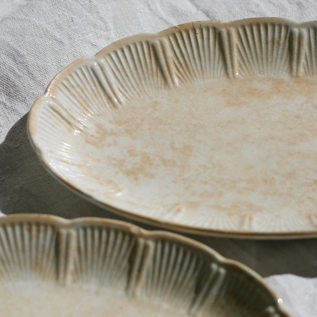 A beautiful pair of French antique ironstone raviers or side plates which over the last century or more have developed a wonderful time-worn and tea-stained finish which make them perfect for shabby chic interior decor. We very rarely come across these little plates lately they're a rare find.