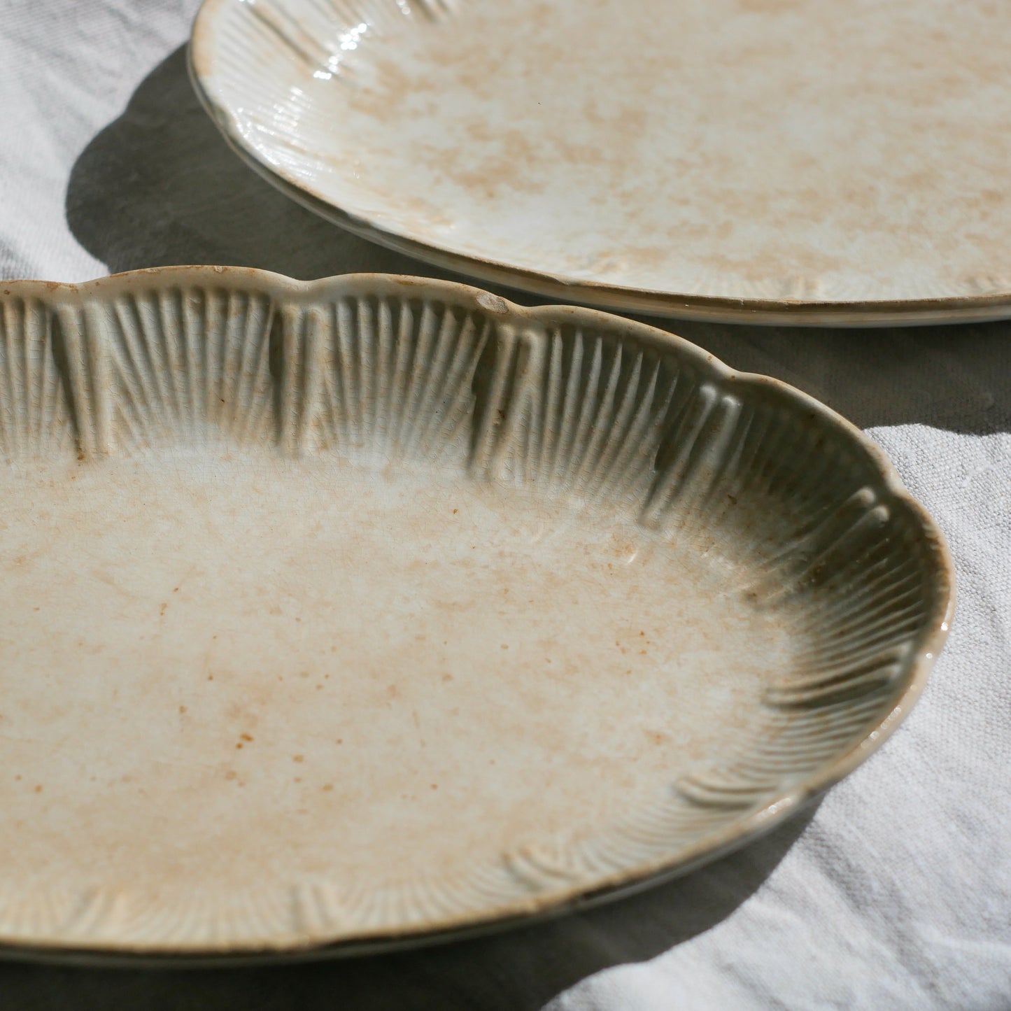 A beautiful pair of French antique ironstone raviers or side plates which over the last century or more have developed a wonderful time-worn and tea-stained finish which make them perfect for shabby chic interior decor. We very rarely come across these little plates lately they're a rare find.