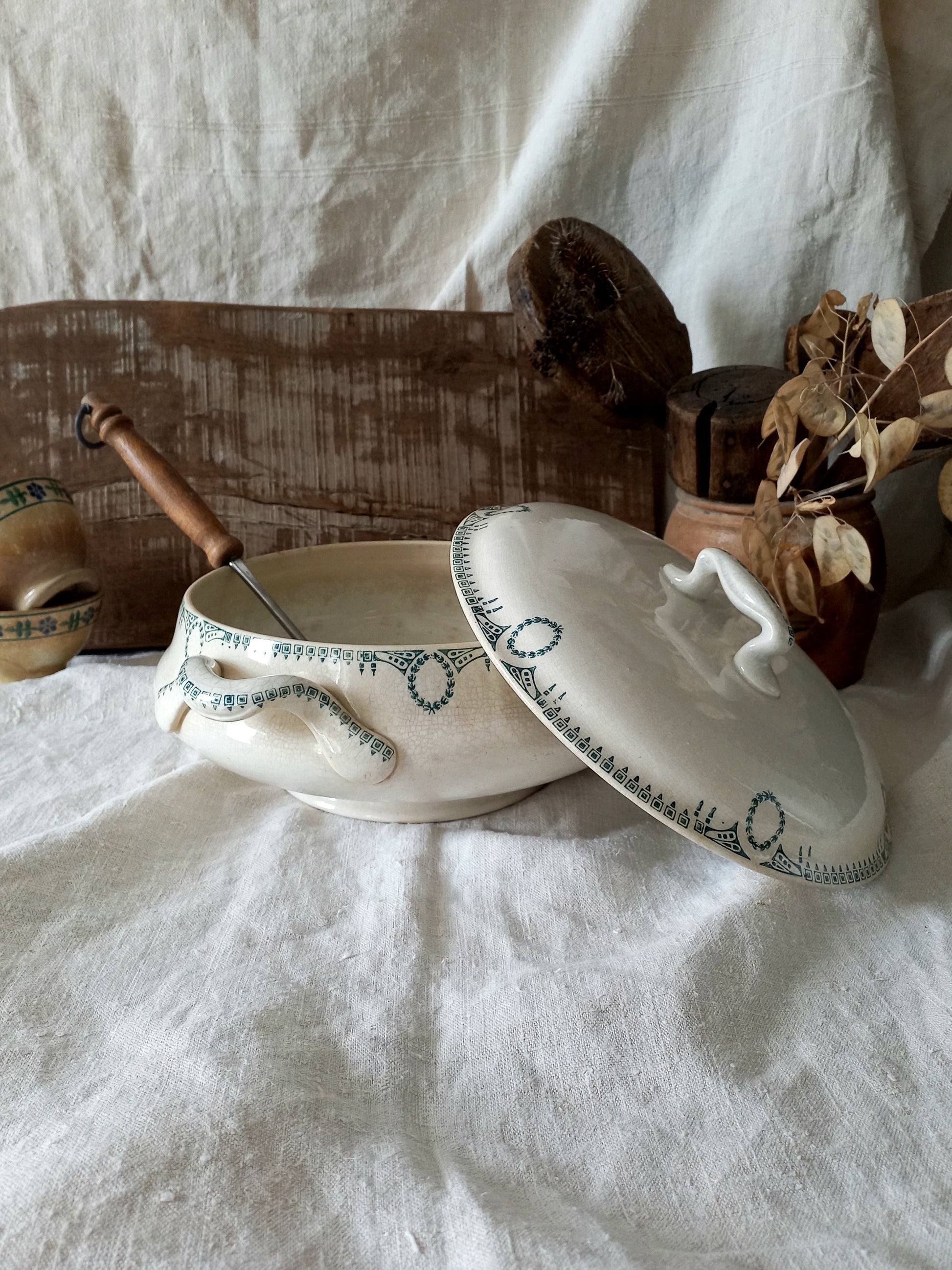Ceramic dish with lid on a white fabric background