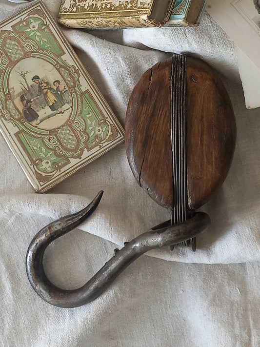 A beautiful aged antique wooden pulley block with a heavy metal hanging hook - a really fantastic piece with many decorative possibilities such a plant hanger or nautical/coastal decor.
