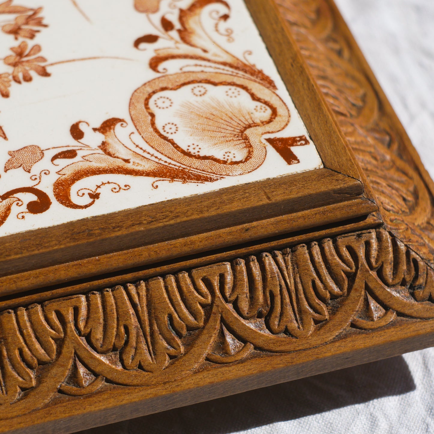 A beautiful French antique wooden trivet with a ceramic bird and floral tile insert. The wooden frame is very decorative with patterns around all four edges while the ceramic tile has aged just enough, the tasteful off-white and light brown colour scheme making this piece a most welcome addition to any kitchen as decor or perhaps as a decorative plant pot stand.