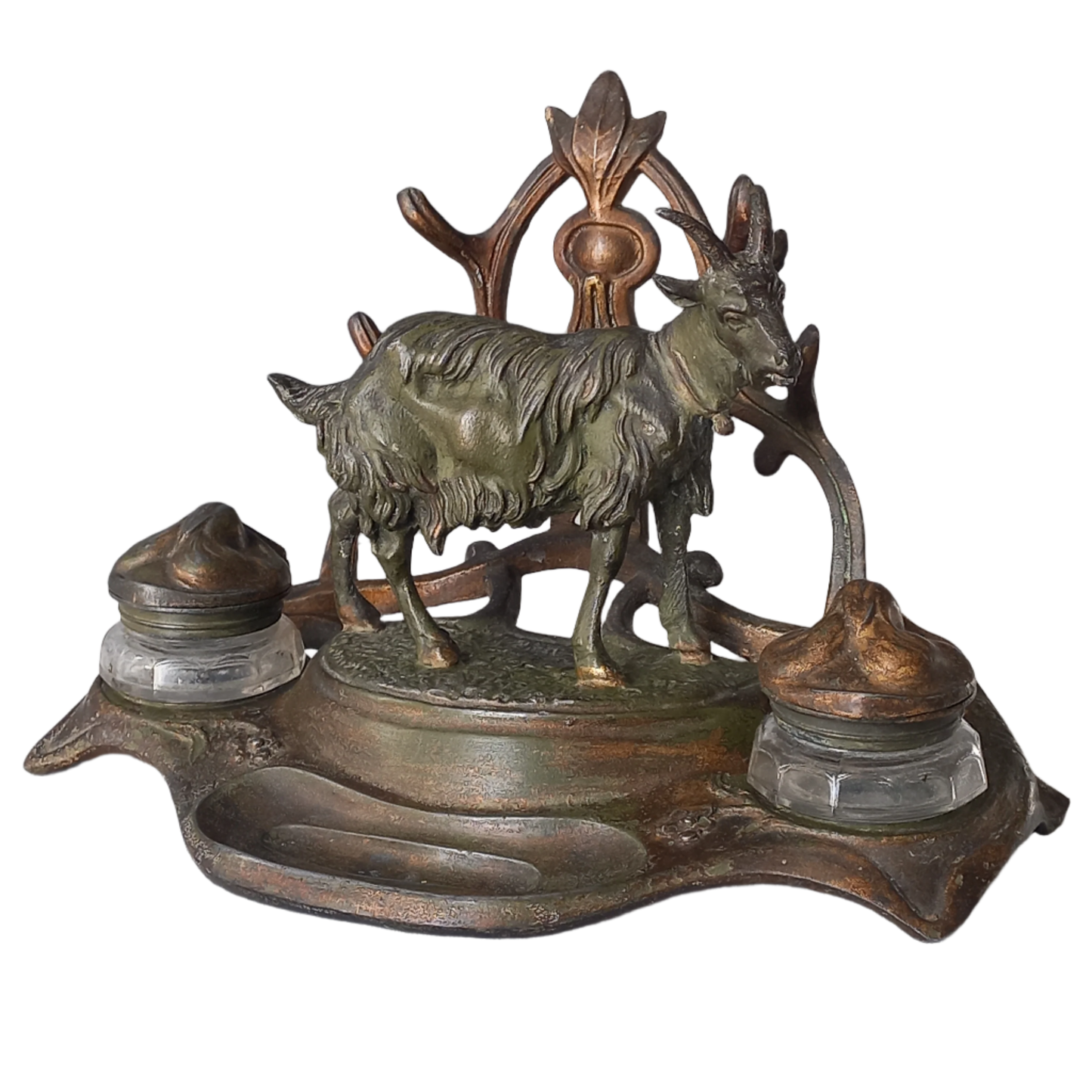 A stunning French art nouveau double inkwell with a goat figurine.

This wonderful antique inkwell has been sculpted in metal and signed by the artist (see photos). Behind the beautiful goat figurine are two pen rests and either side of the goat are two small glass ink pots with decorative metal lids.

The metal is finished in a lovely shade of green that has worn over time with traces of gold colour beneath - it has a wonderful patina of time all over it.