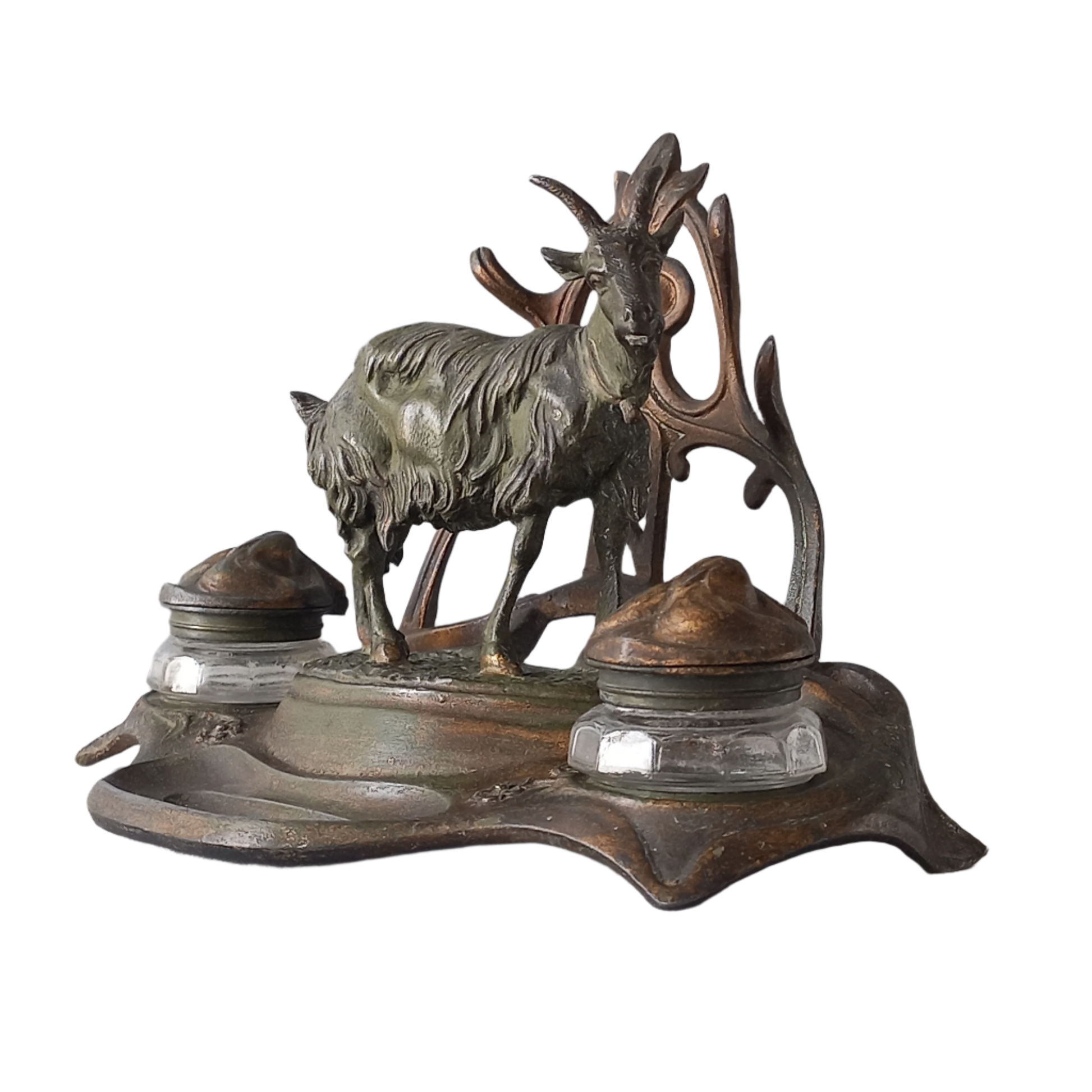 A stunning French art nouveau double inkwell with a goat figurine.

This wonderful antique inkwell has been sculpted in metal and signed by the artist (see photos). Behind the beautiful goat figurine are two pen rests and either side of the goat are two small glass ink pots with decorative metal lids.

The metal is finished in a lovely shade of green that has worn over time with traces of gold colour beneath - it has a wonderful patina of time all over it.