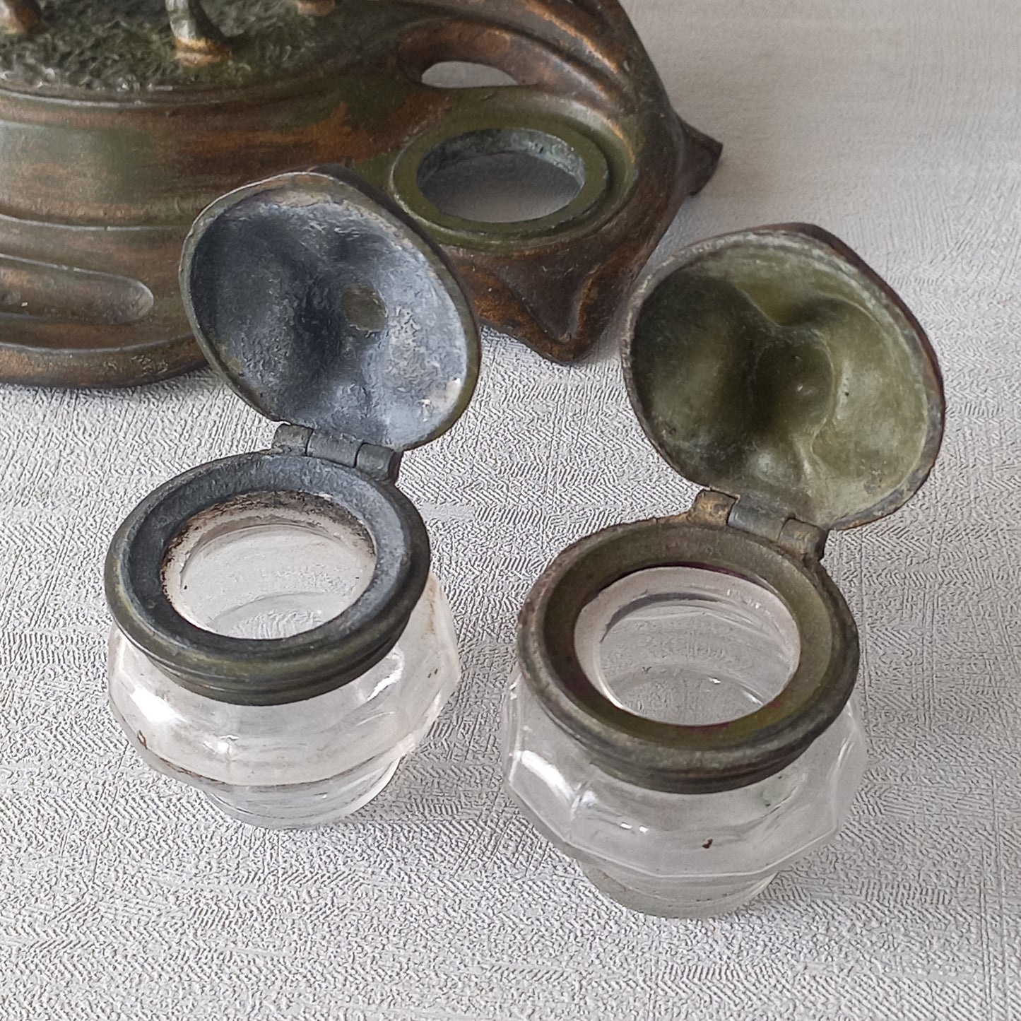 A stunning French art nouveau double inkwell with a goat figurine.

This wonderful antique inkwell has been sculpted in metal and signed by the artist (see photos). Behind the beautiful goat figurine are two pen rests and either side of the goat are two small glass ink pots with decorative metal lids.

The metal is finished in a lovely shade of green that has worn over time with traces of gold colour beneath - it has a wonderful patina of time all over it.