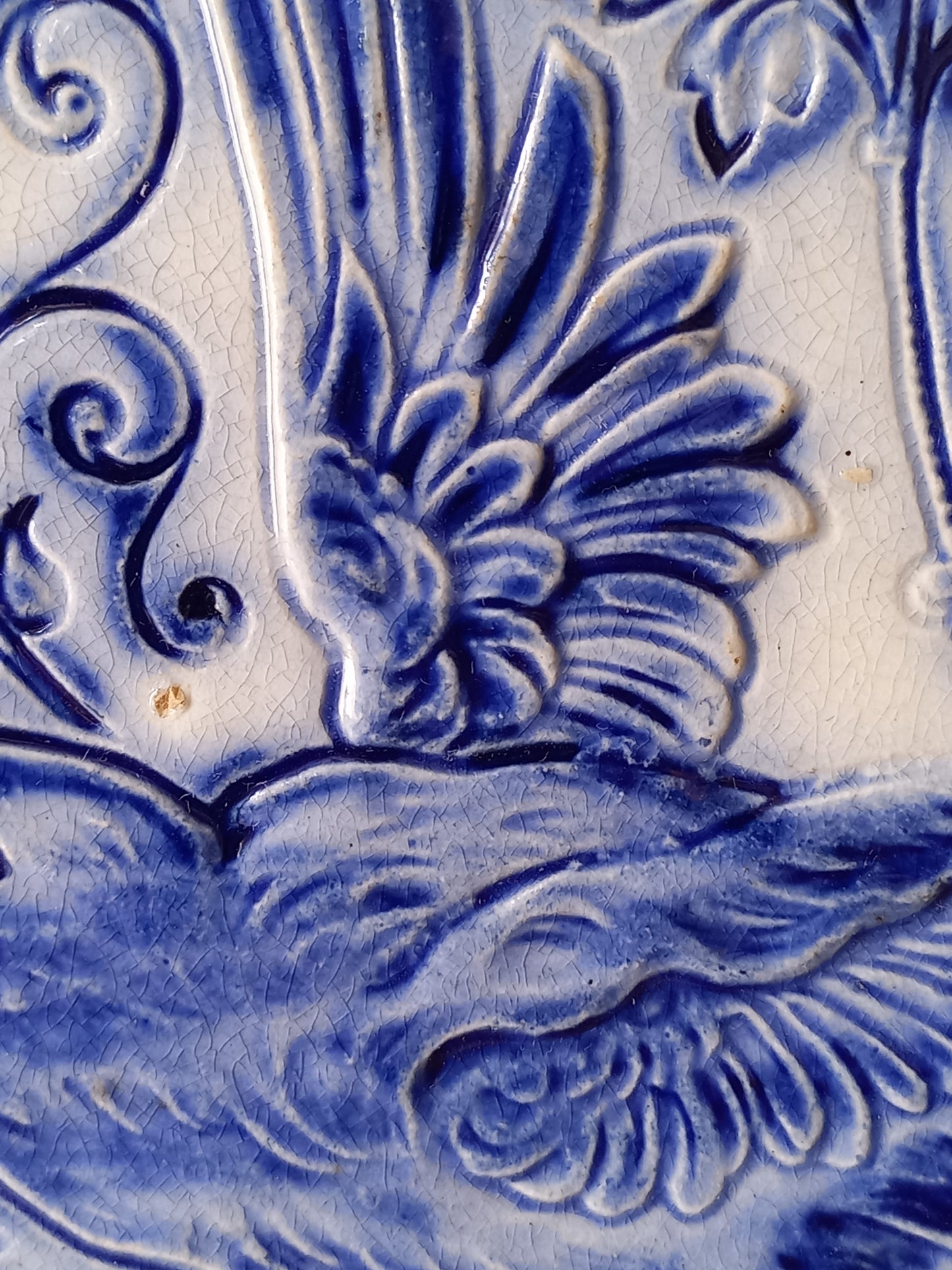Close-up view of antique decorative majolica plate by premier Belgian manufacture, Wasmuel.