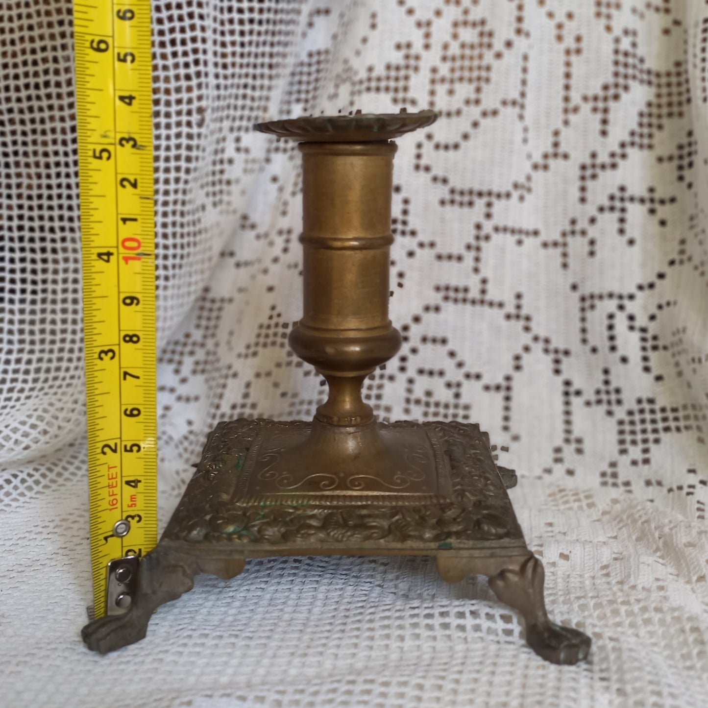 Small decorative antique candle stick holder with four little feet