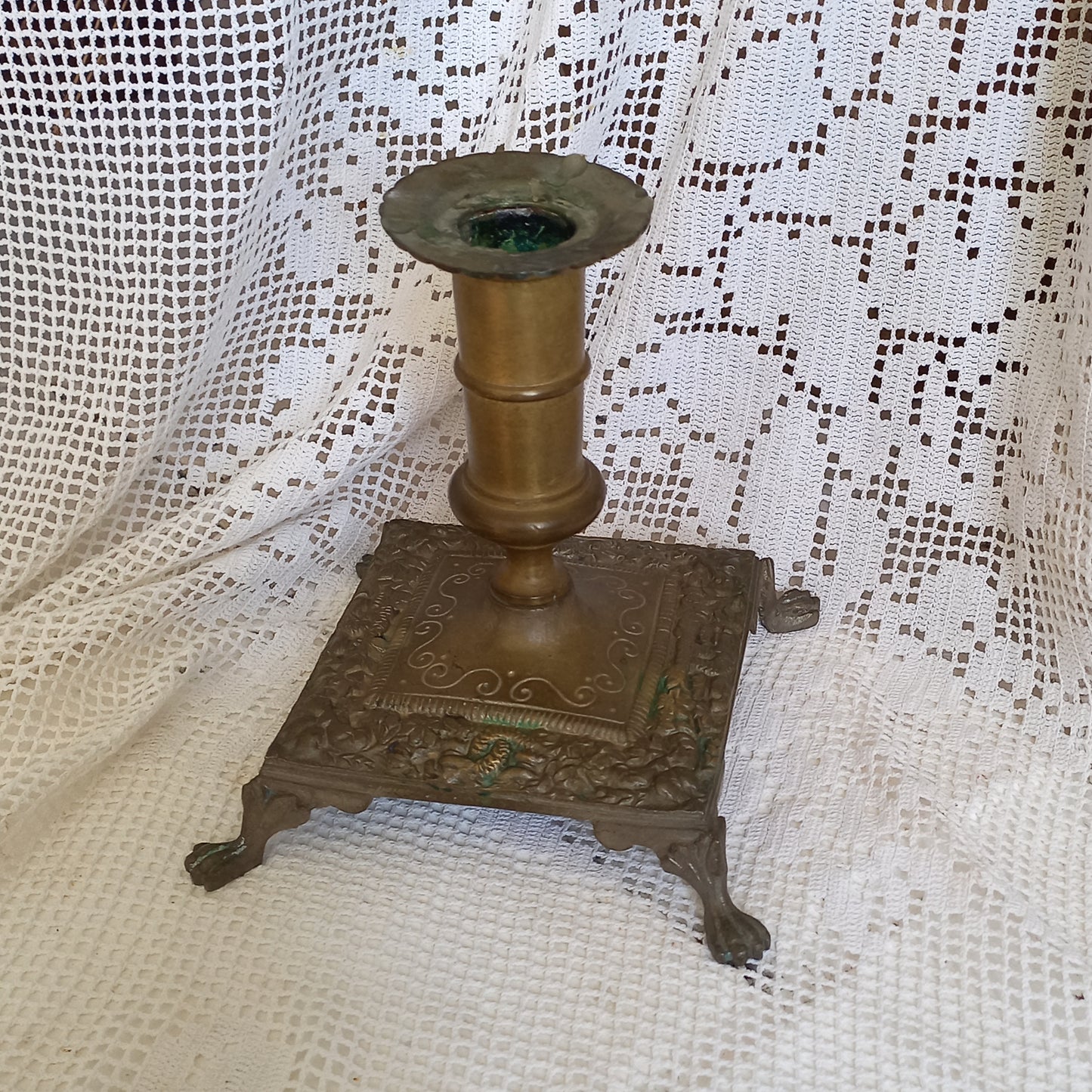 Small decorative antique candle stick holder with four little feet