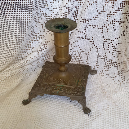 Small decorative antique candle stick holder with four little feet