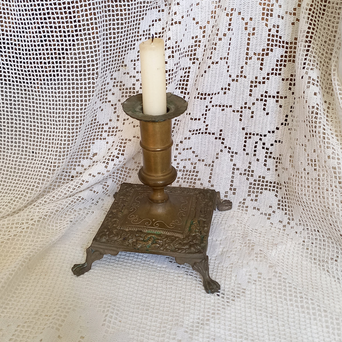 Small decorative antique candle stick holder with four little feet
