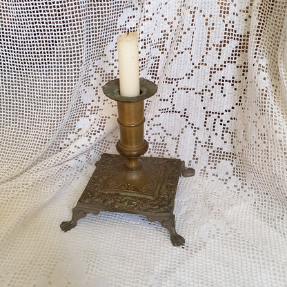 Small decorative antique candle stick holder with four little feet