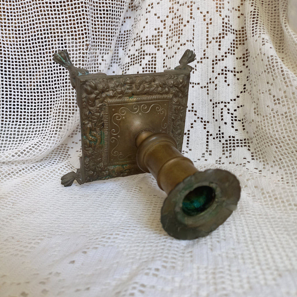 Small decorative antique candle stick holder with four little feet