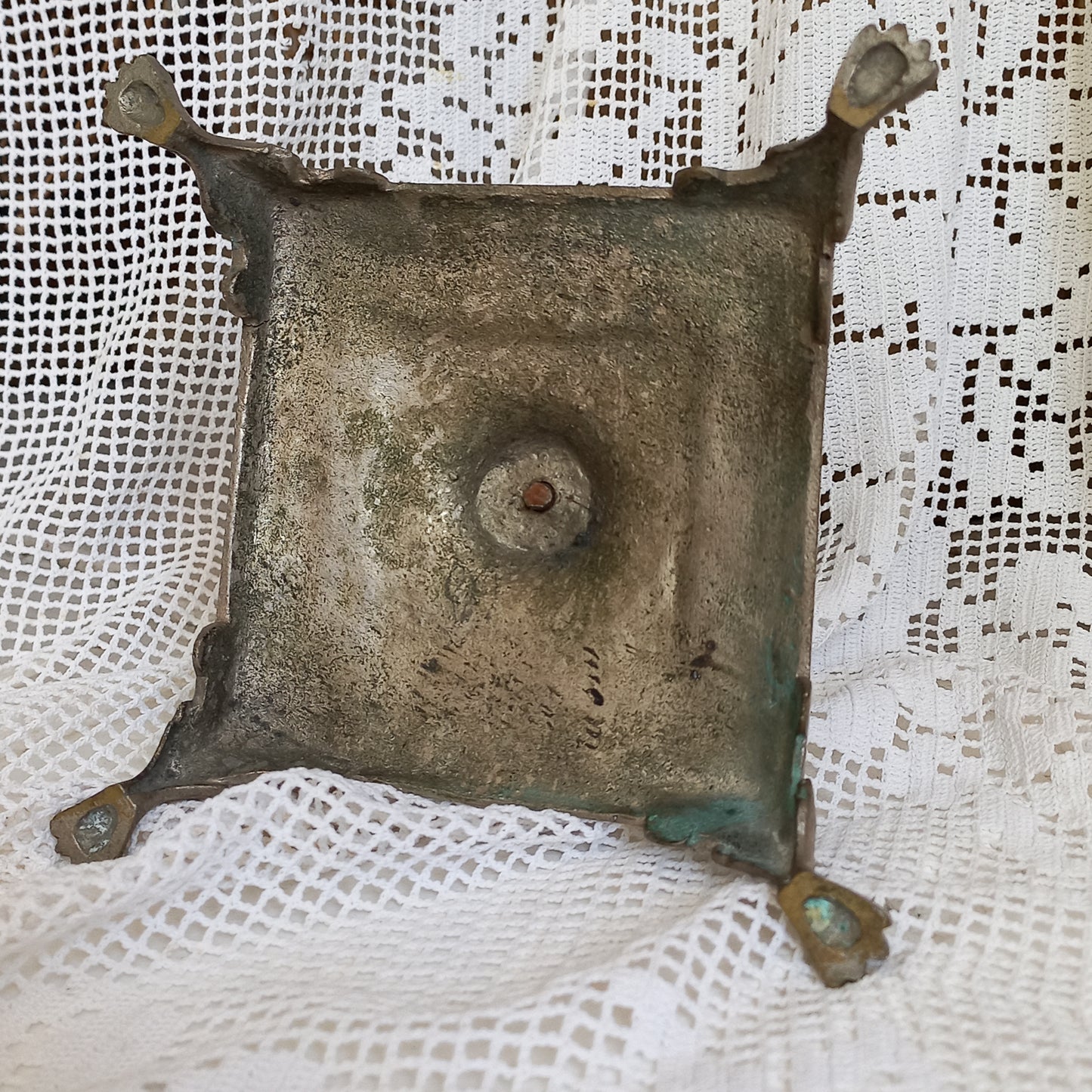 Small decorative antique candle stick holder with four little feet