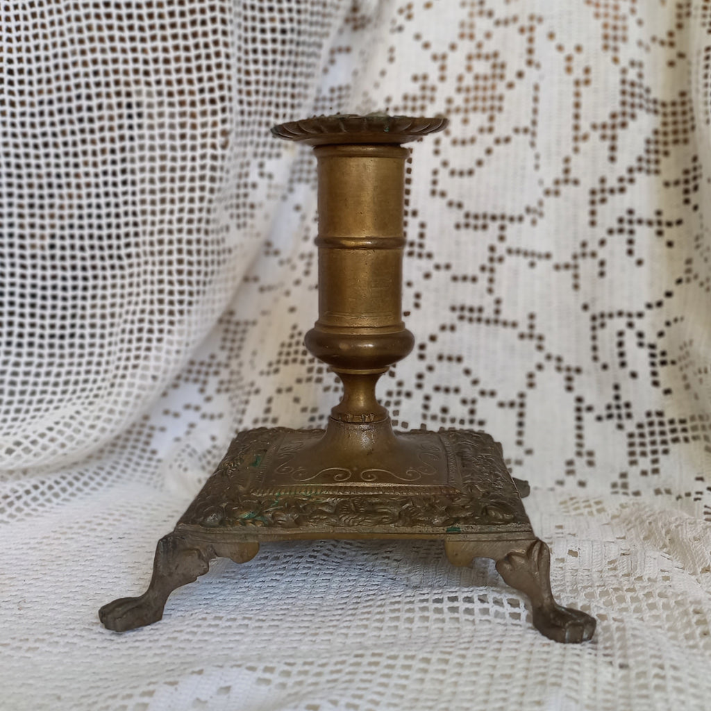 Small decorative antique candle stick holder with four little feet