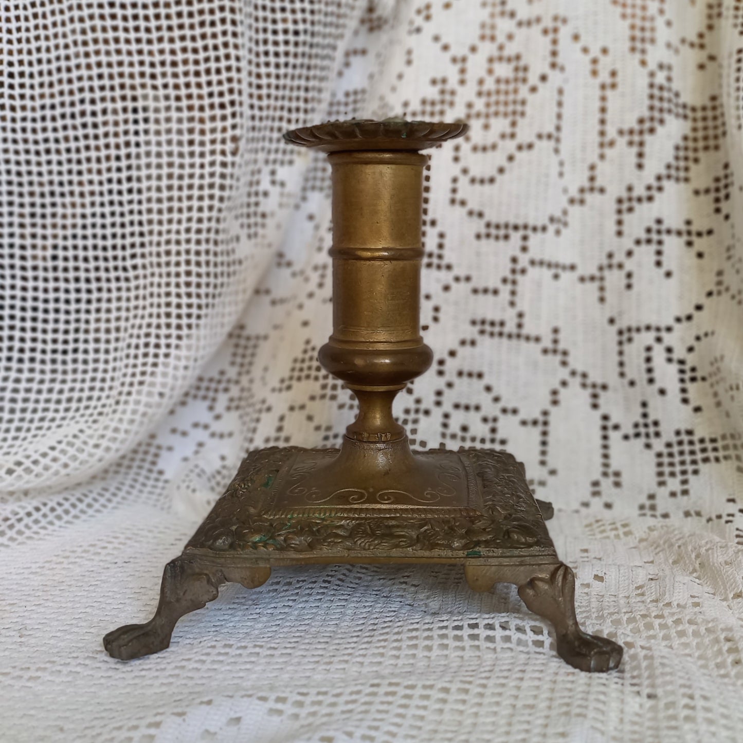 Small decorative antique candle stick holder with four little feet