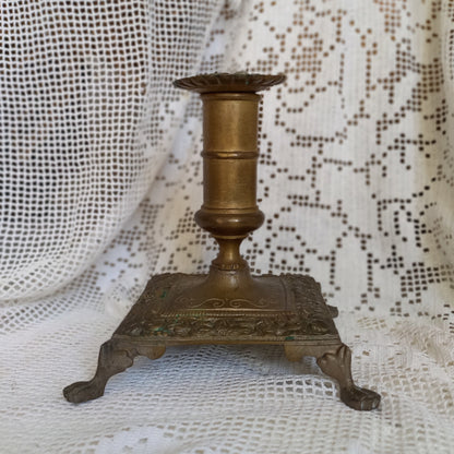 Small decorative antique candle stick holder with four little feet