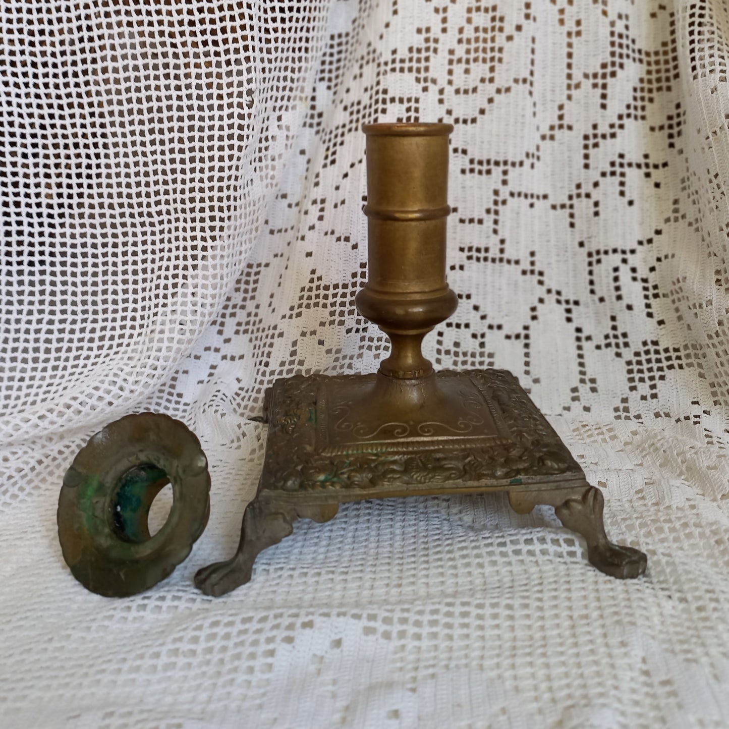 Small decorative antique candle stick holder with four little feet