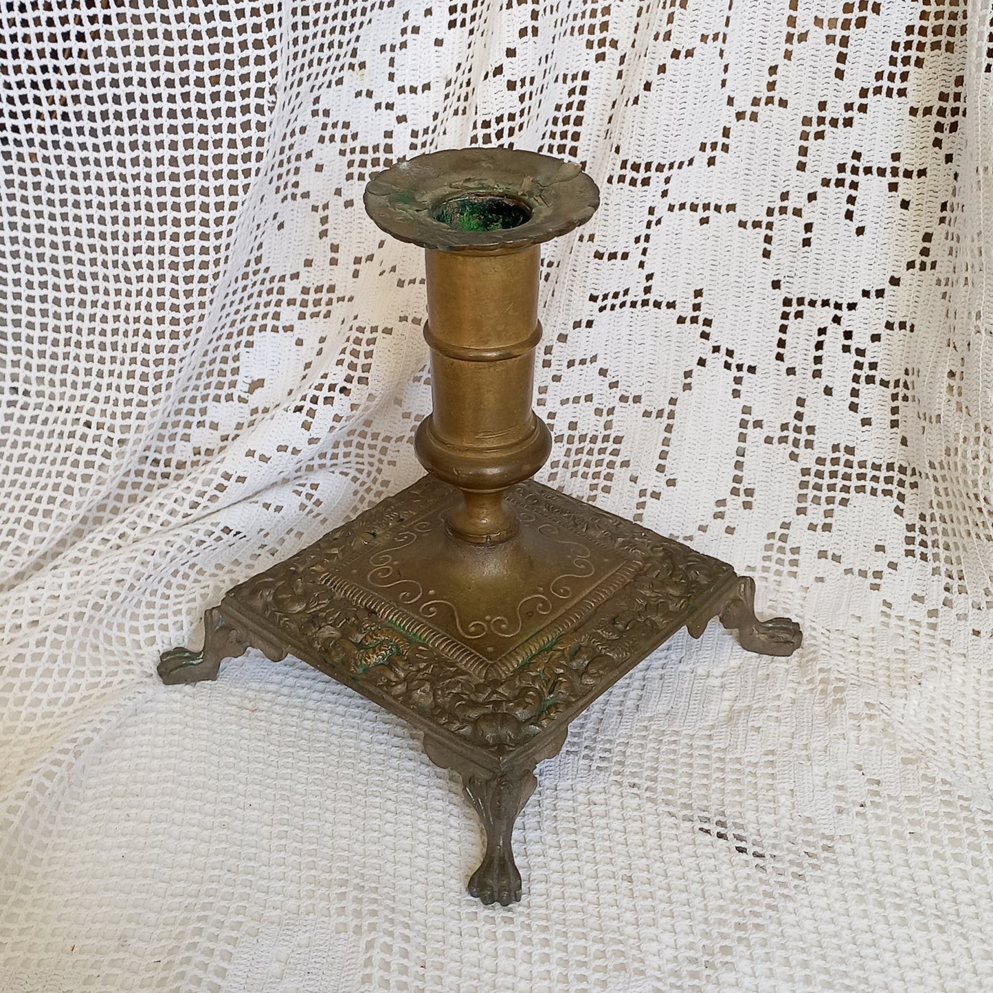 Small decorative antique candle stick holder with four little feet