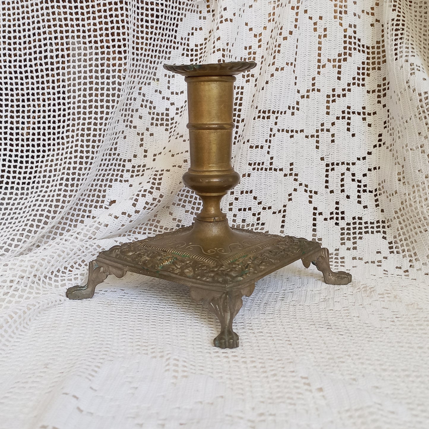 Small decorative antique candle stick holder with four little feet