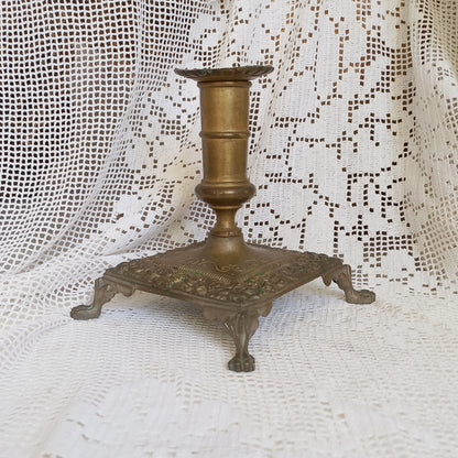 Small decorative antique candle stick holder with four little feet