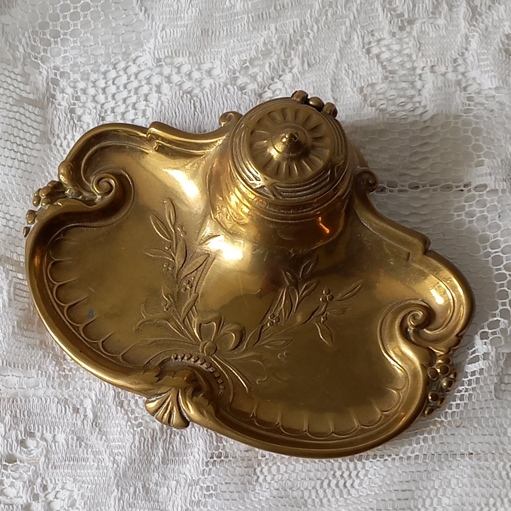 Decorative vintage brass inkwell with white porcelain ink cup