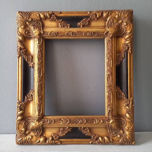 Stunning vintage frame for a painting or photo with ornate decoration in an antique style from France. This frame is a solid and heavy piece, seems to be wooden although we also think there might be some plaster so we are calling it a frame made of mixed materials.