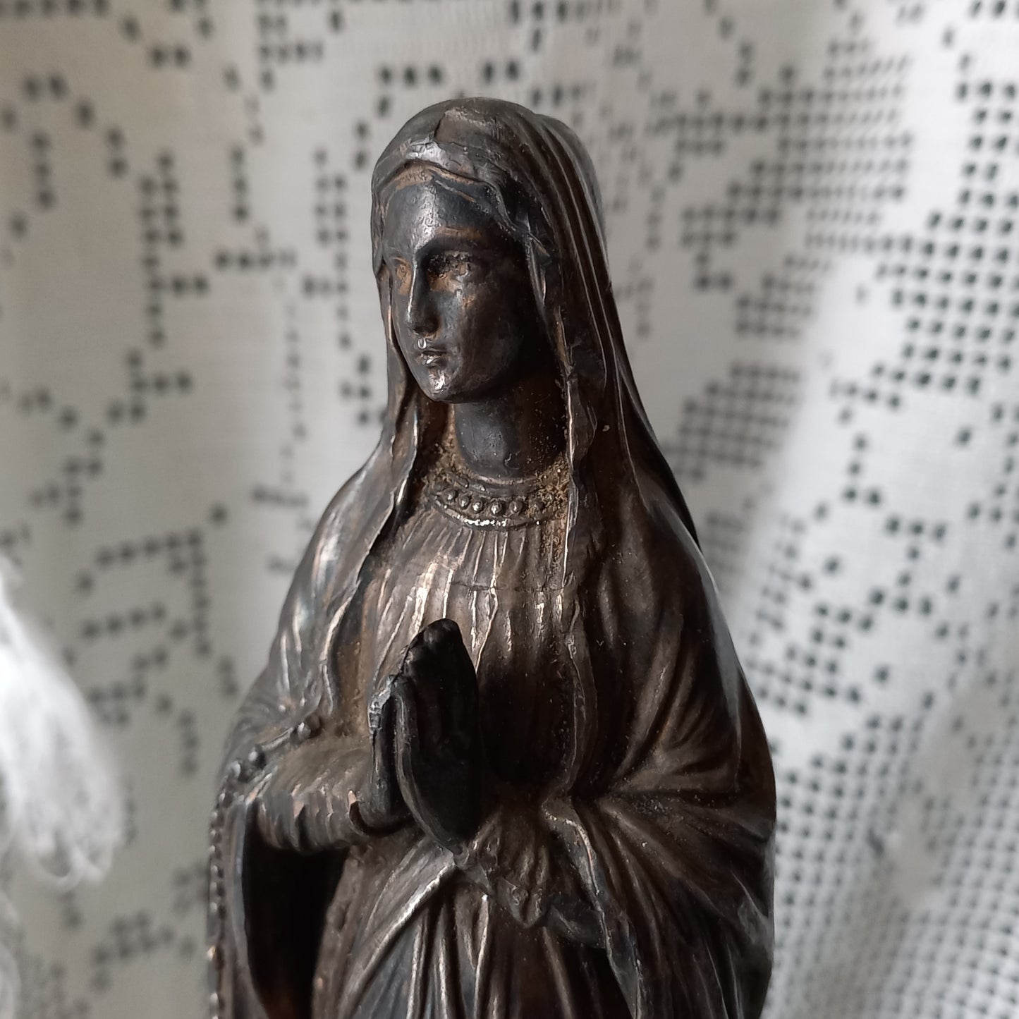 Small Virgin Mary religious figurine made from metal