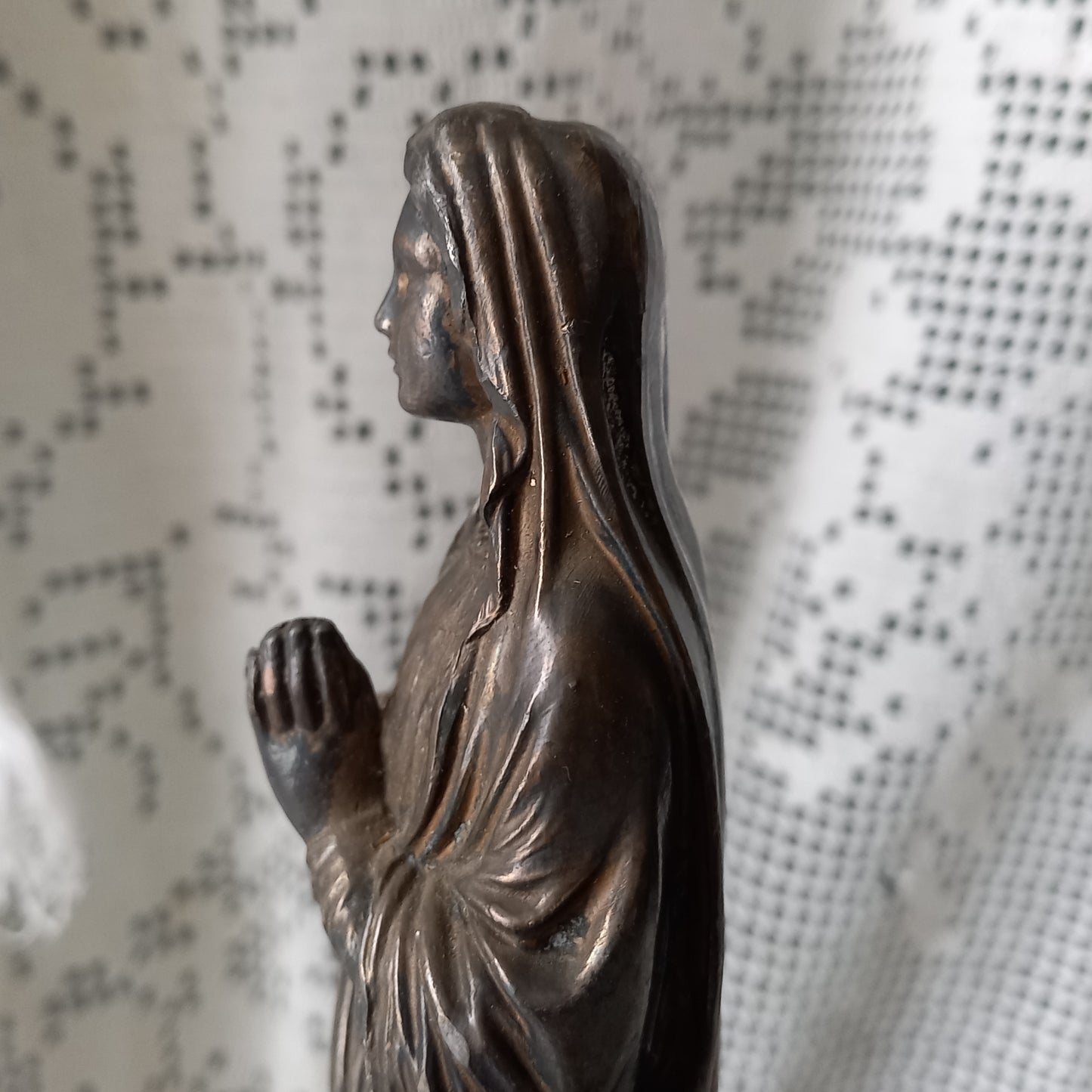 Small Virgin Mary religious figurine made from metal