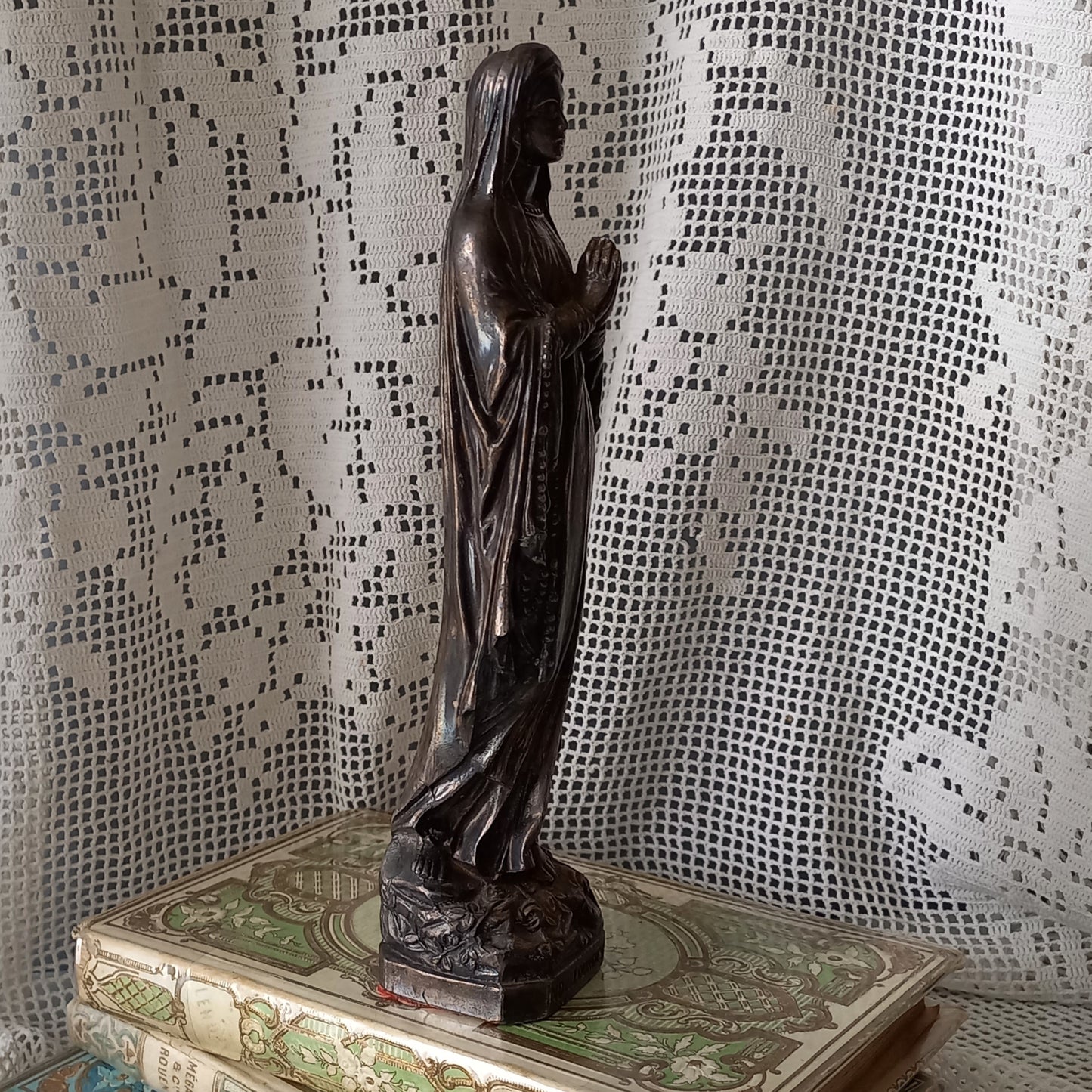 Small Virgin Mary religious figurine made from metal