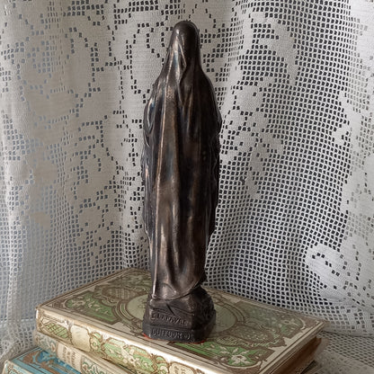 Small Virgin Mary religious figurine made from metal