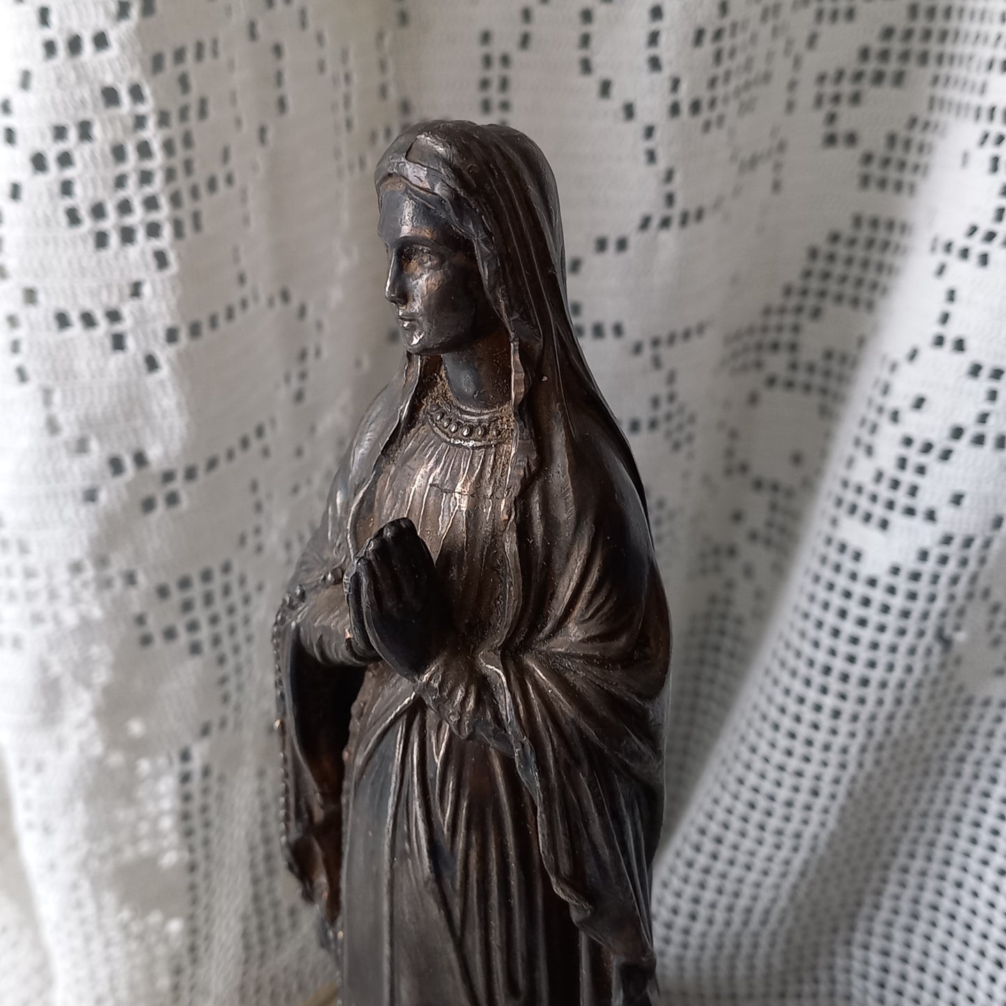 Small Virgin Mary religious figurine made from metal