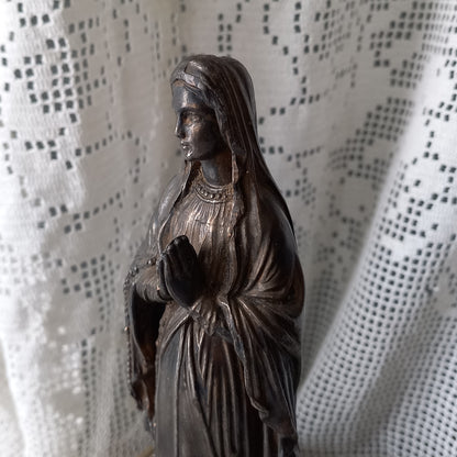 Small Virgin Mary religious figurine made from metal