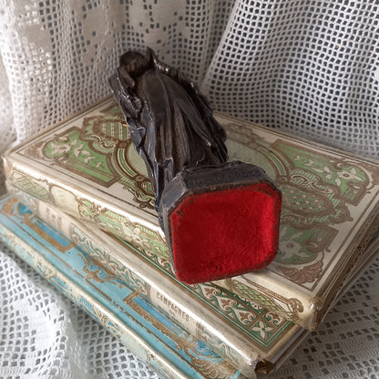 Small Virgin Mary religious figurine made from metal