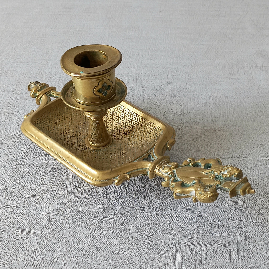 A French antique bronze/brass candle holder or chamber stick, a quality piece that is highly detailed with engraved patterns and a coat of arms with two lovely lions on the handle! This is a heavy piece for its small size and will make super home decor in any interior.