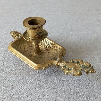 A French antique bronze/brass candle holder or chamber stick, a quality piece that is highly detailed with engraved patterns and a coat of arms with two lovely lions on the handle! This is a heavy piece for its small size and will make super home decor in any interior.