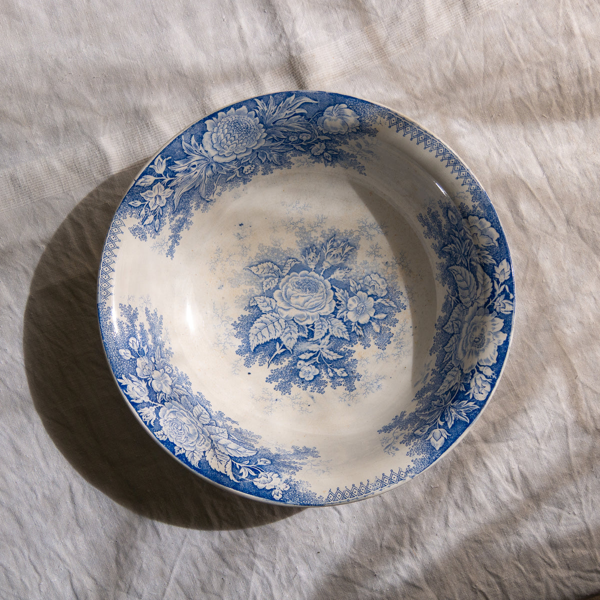 A large and beautiful antique white ironstone bowl or wash basin with blue floral pattern by premier French manufacturer, Sarreguemines.
This piece is circa. 1875 - 1900 so well over 100 years old! 
A stunning piece of original antique ironstone from France that will make excellent home decor.