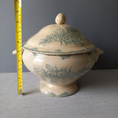 A pretty antique ironstone soup tureen with aged and faded floral transfer pattern in a beautiful shade of blue green or teal. Over time this wonderful old tureen has developed a pleasing faded creamy white finish. In summary, a beautiful piece of authentic antique ironstone from France.