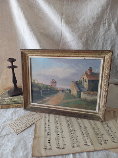 Framed painting of a rural, coastal village scene with sheet music underneath