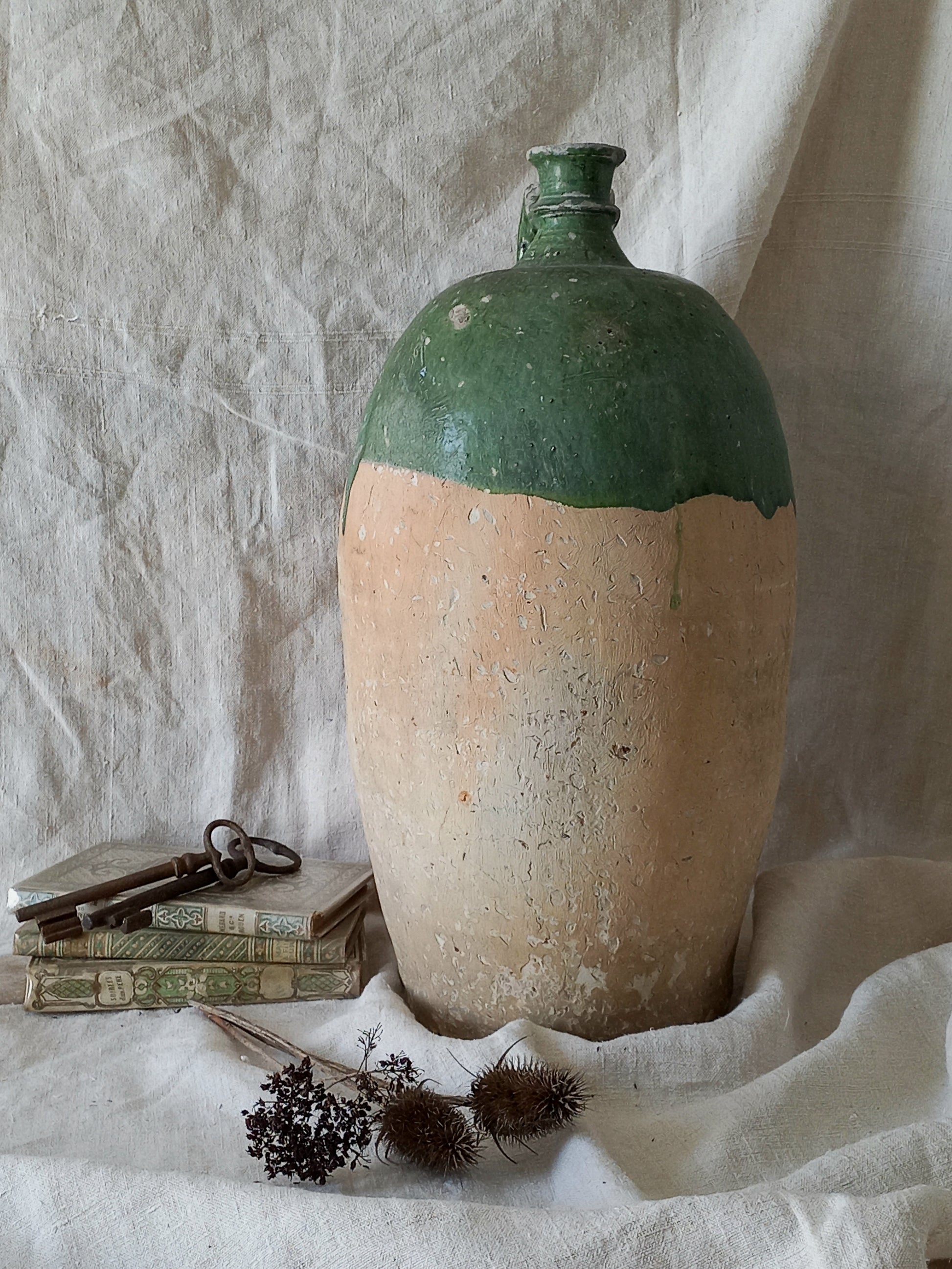 A rare and very large French antique stoneware preserving jar in a lovely shade of green over an earthy beige.
