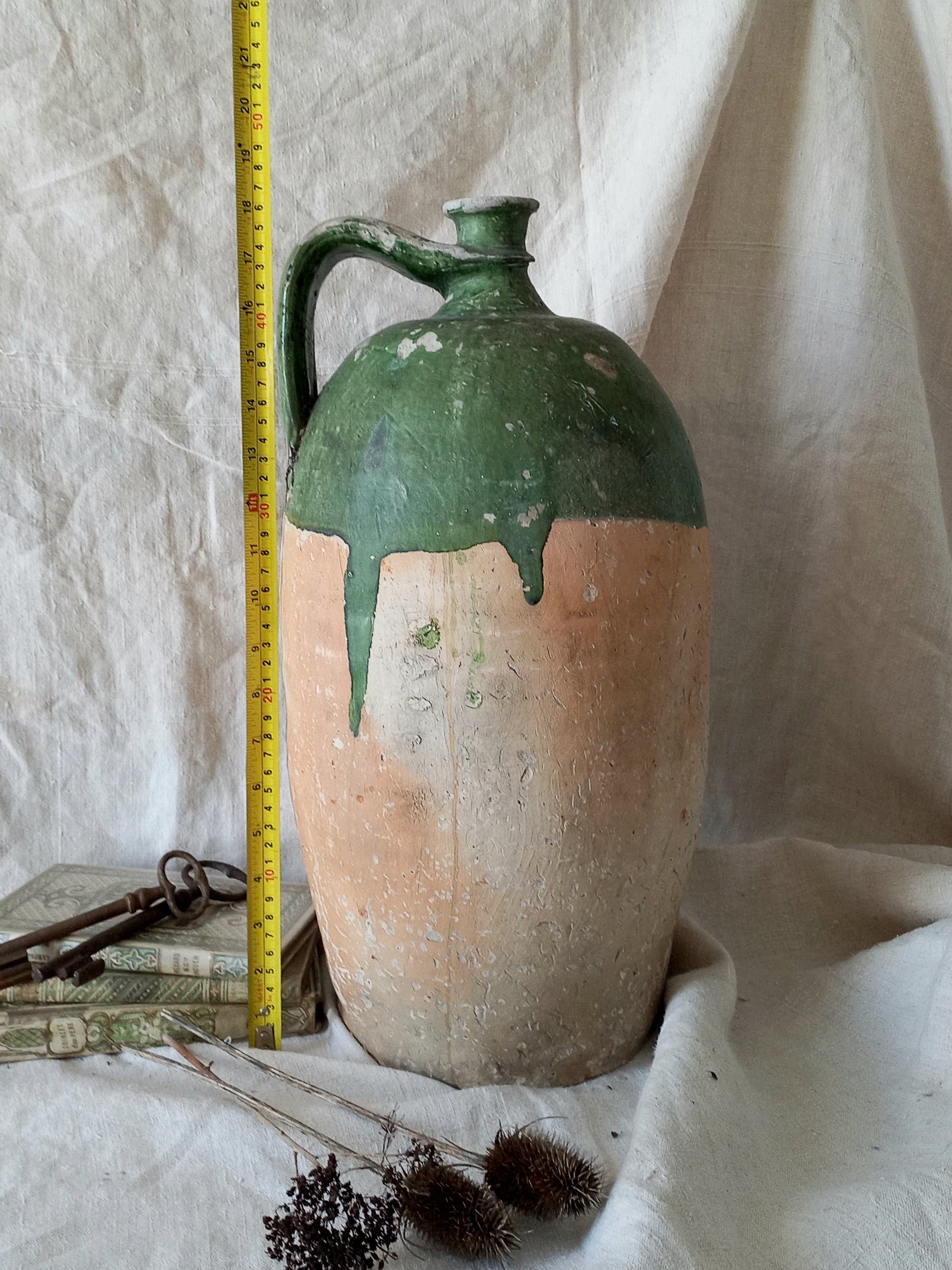 A rare and very large French antique stoneware preserving jar in a lovely shade of green over an earthy beige.
