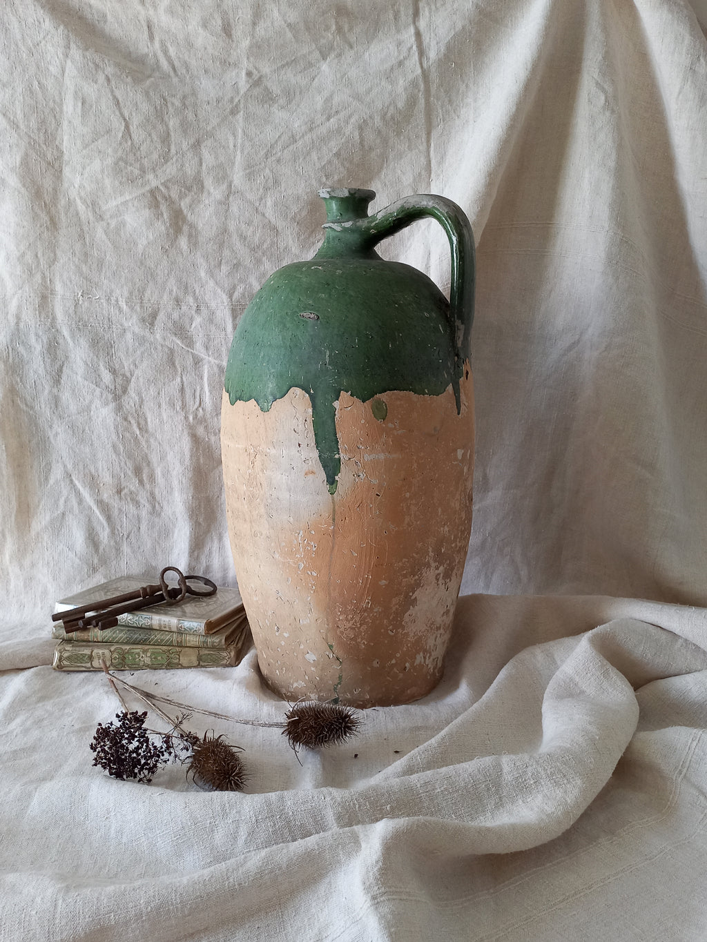A rare and very large French antique stoneware preserving jar in a lovely shade of green over an earthy beige.
