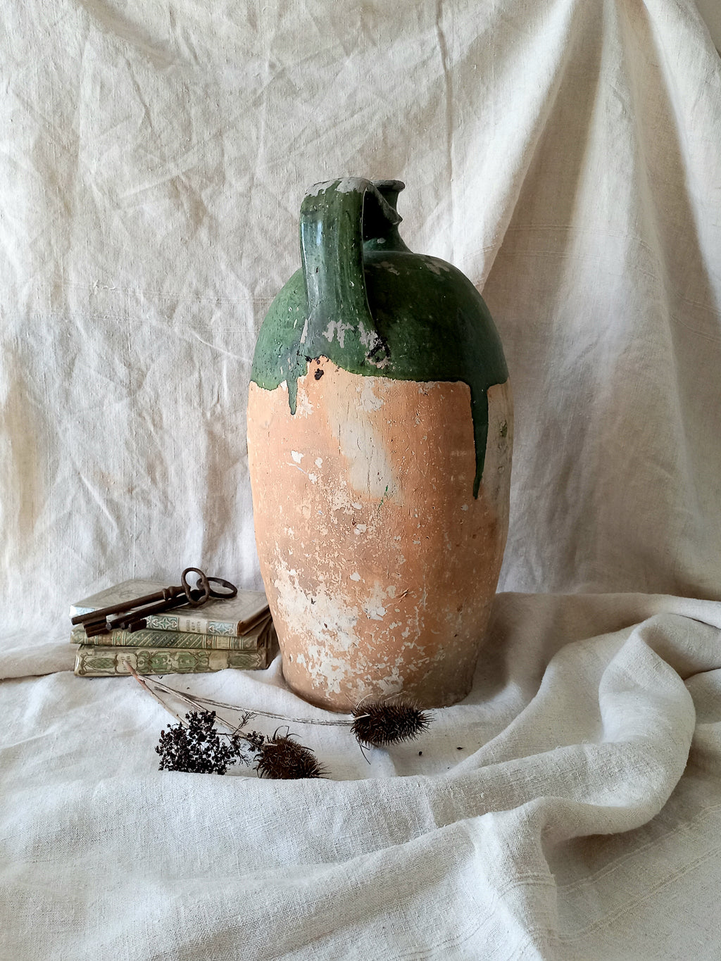 A rare and very large French antique stoneware preserving jar in a lovely shade of green over an earthy beige.
