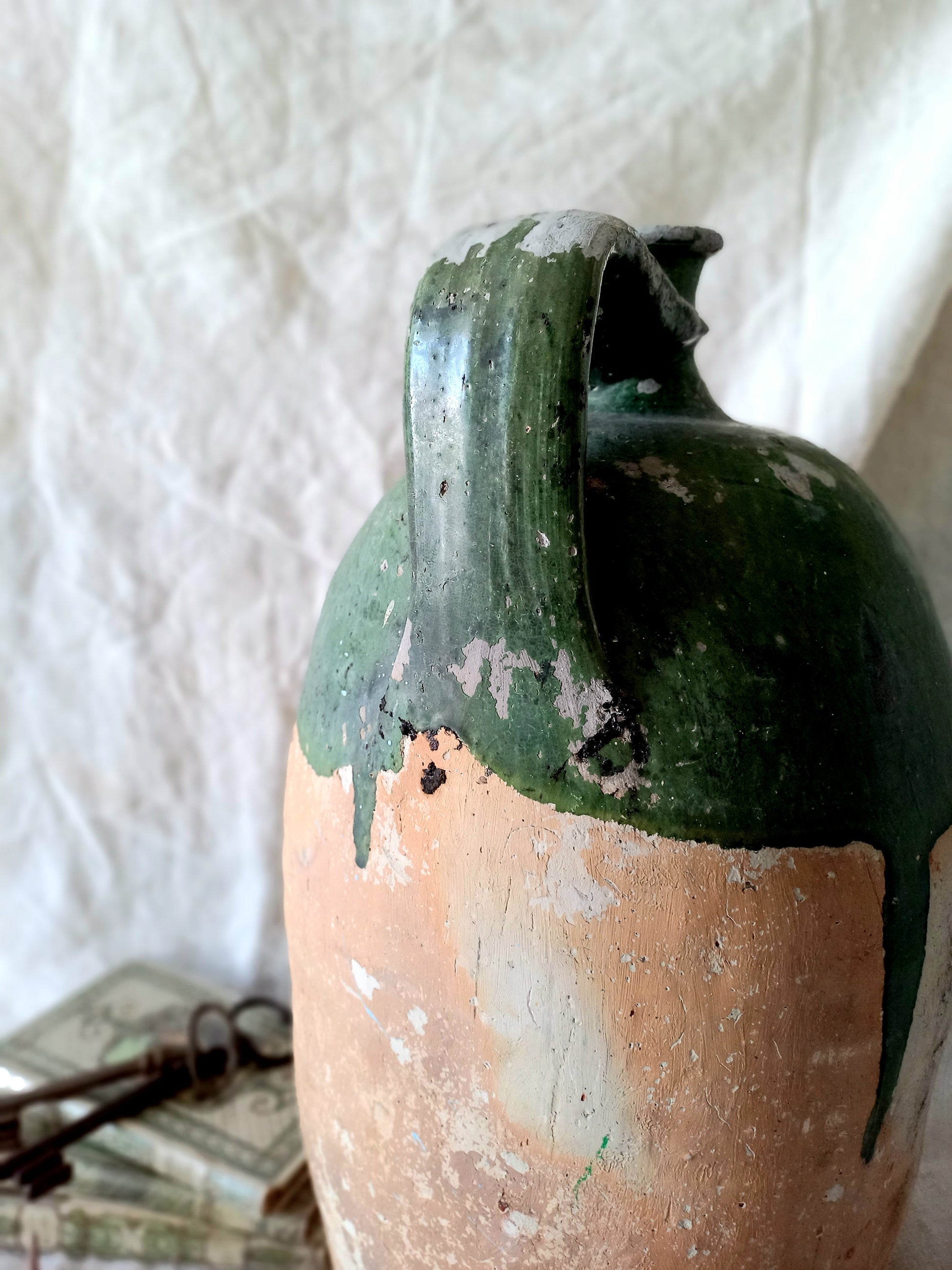 A rare and very large French antique stoneware preserving jar in a lovely shade of green over an earthy beige.
