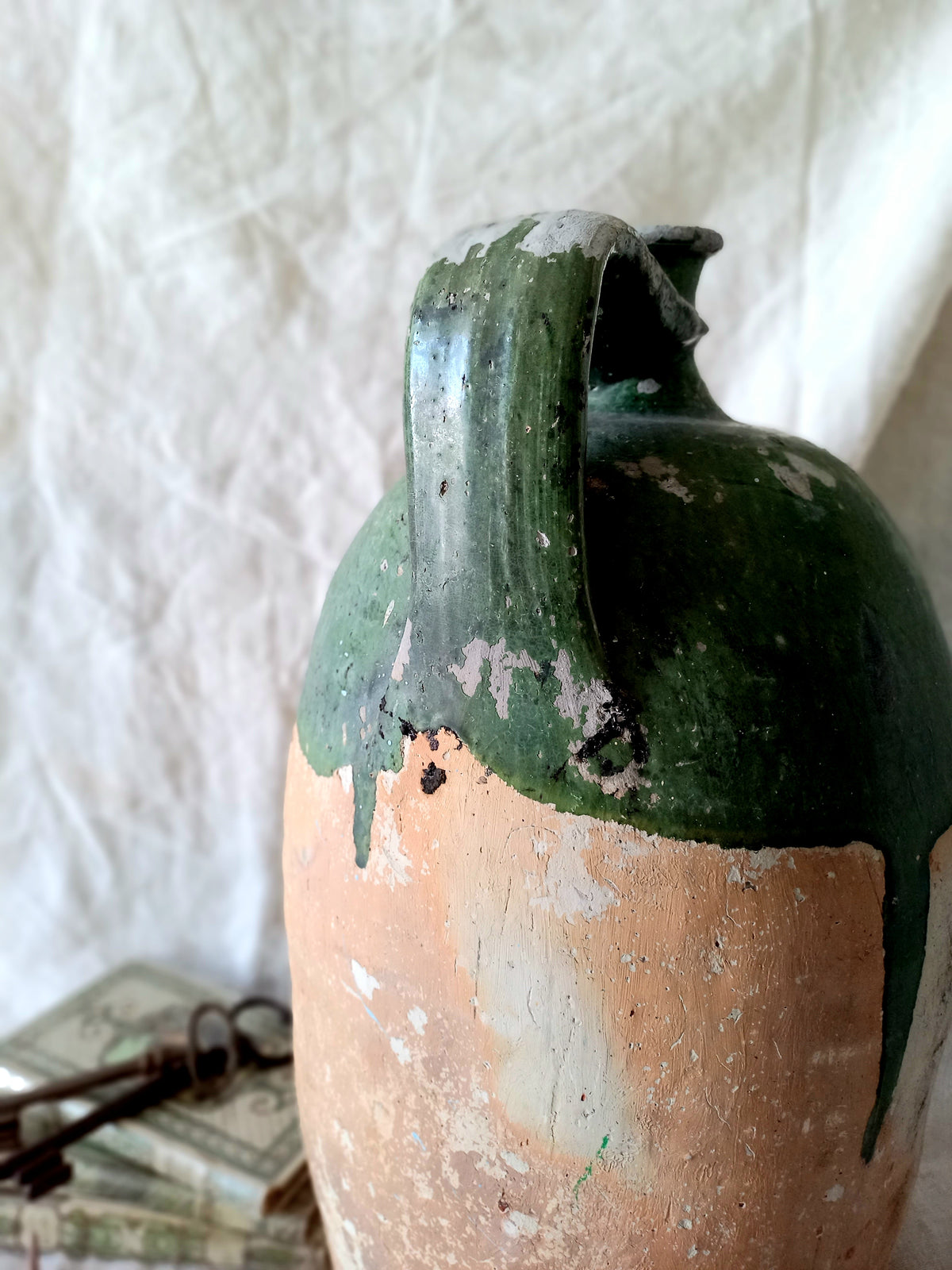 A rare and very large French antique stoneware preserving jar in a lovely shade of green over an earthy beige.

