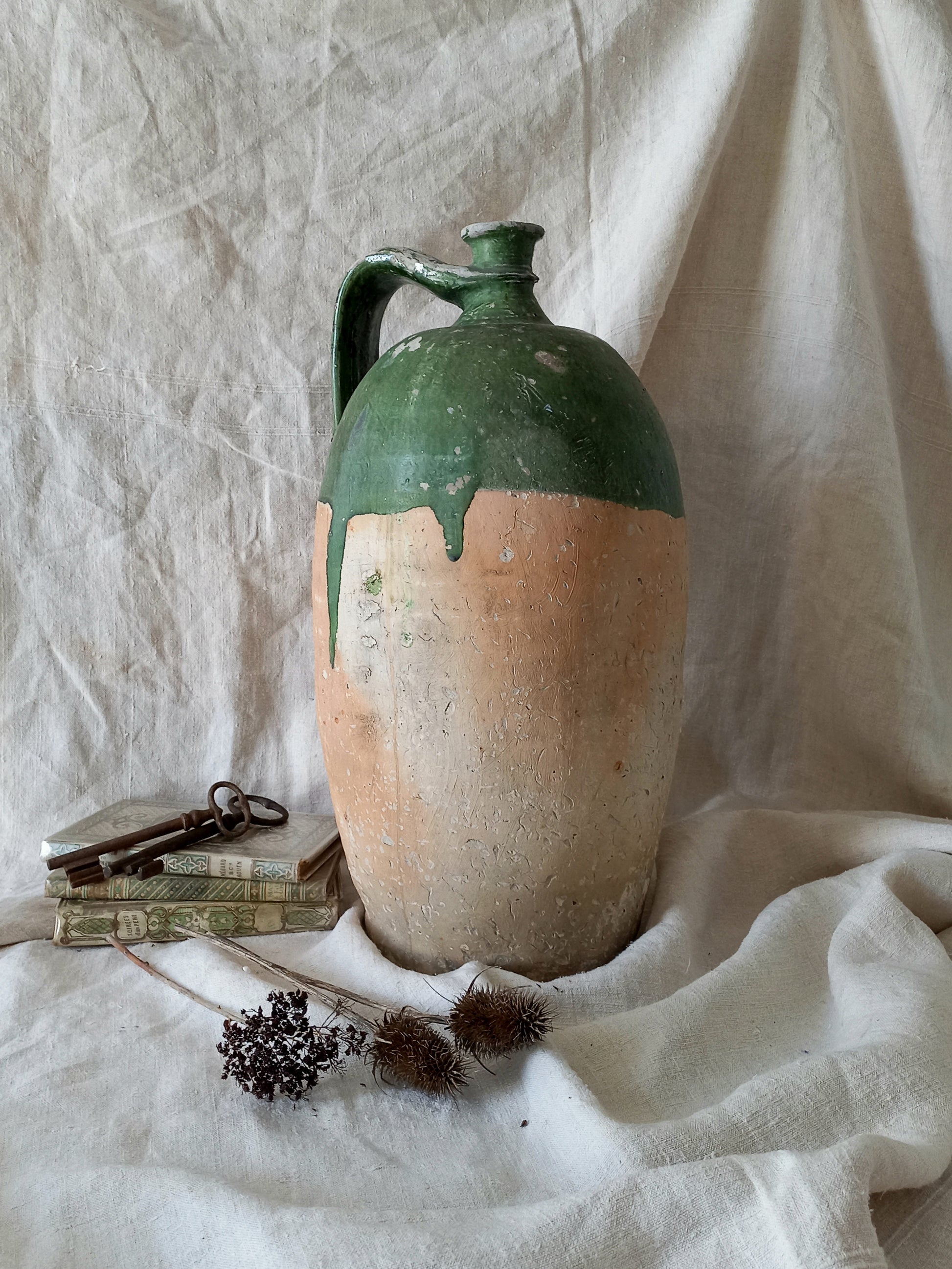 A rare and very large French antique stoneware preserving jar in a lovely shade of green over an earthy beige.
