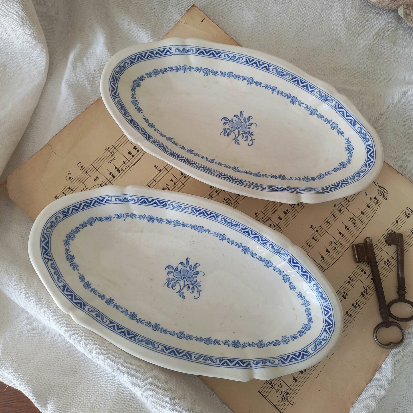 A beautiful pair of French vintage white ironstone side plates or raviers with attractive blue designs. These particular pieces were manufactured by Gien.