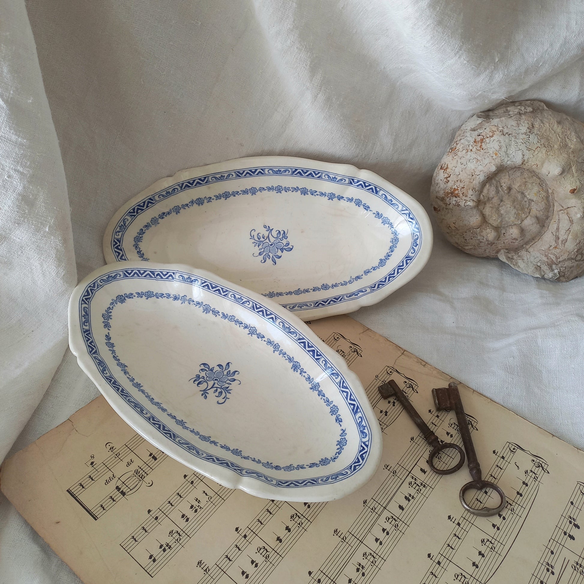 A beautiful pair of French vintage white ironstone side plates or raviers with attractive blue designs. These particular pieces were manufactured by Gien.
