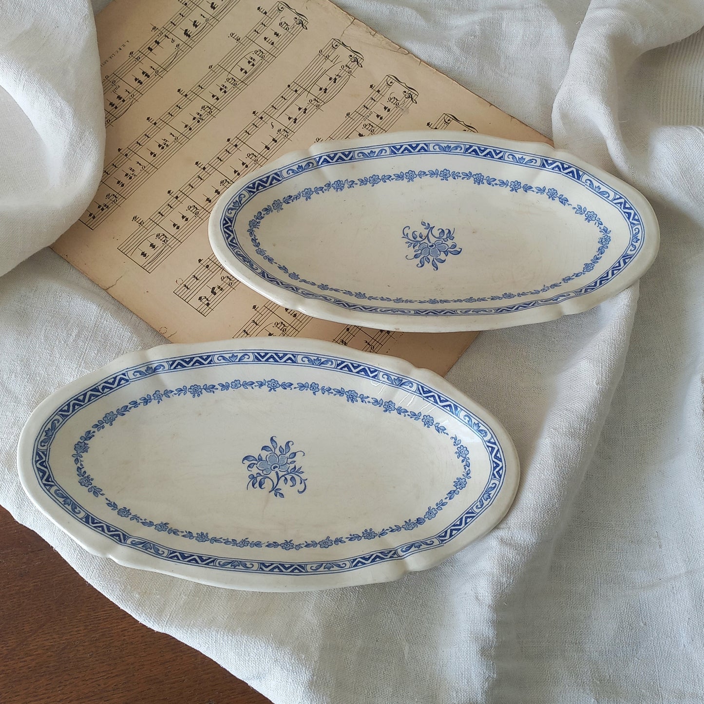 A beautiful pair of French vintage white ironstone side plates or raviers with attractive blue designs. These particular pieces were manufactured by Gien.