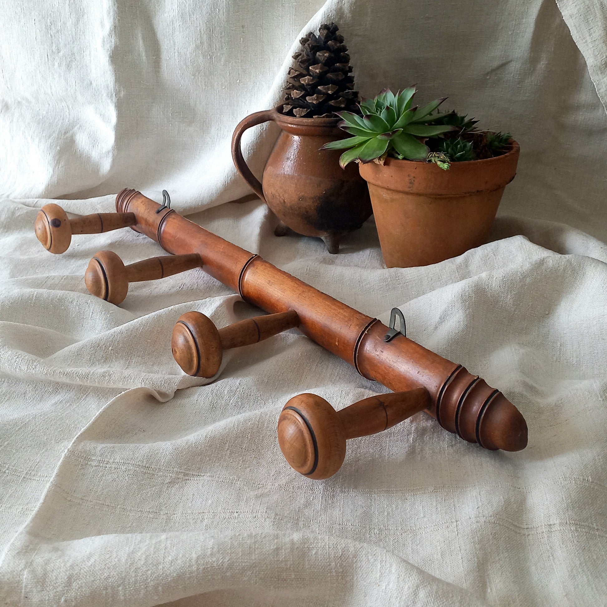 A French vintage faux bamboo wooden coat rack with 4 hanging hooks/pegs. These older type of faux bamboo coat racks are becoming increasingly difficult to source, especially in this excellent condition! There are two metal hanging hooks to the rear for mounting to your wall.

In summary, a wonderful piece of wall decor for any interior, and especially those of a country home, rustic or farmhouse style.